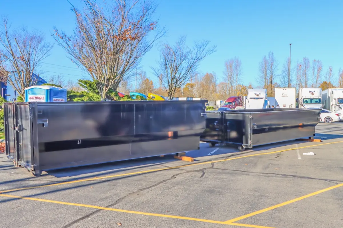 Professional dumpster rental service with roll-off container on residential driveway in Cresaptown